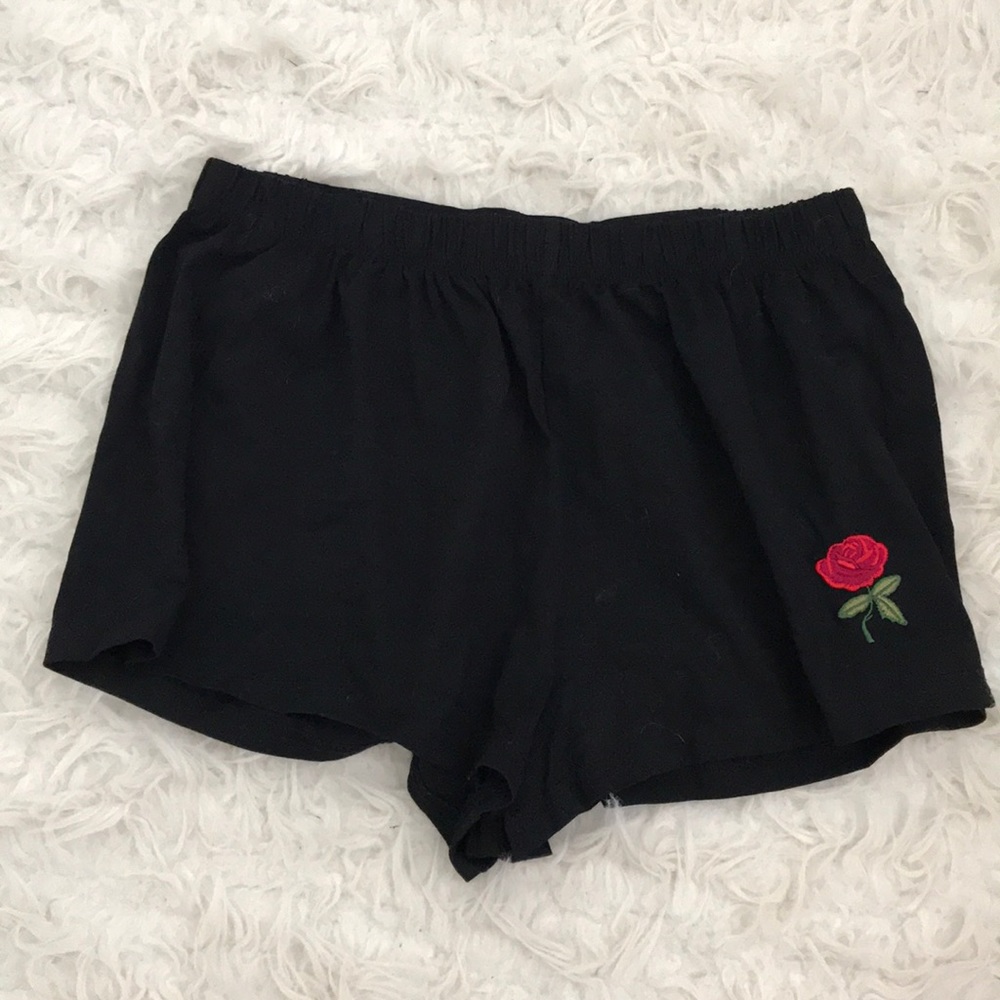 black shorts with embroidered rose.